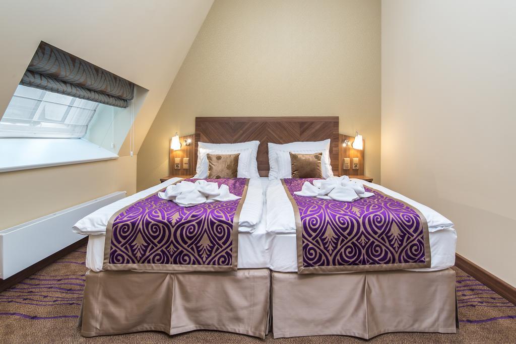 Merchants Crown Suites And Spa براغ المظهر الخارجي الصورة A bed with a bed skirt